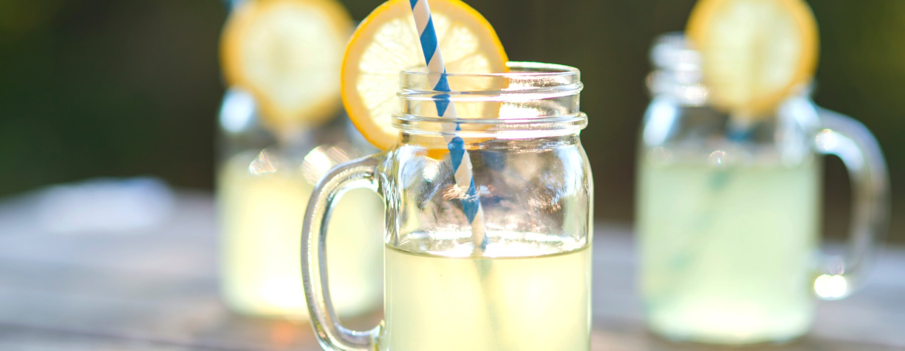Lemonade in a mason style cup with a straw 
